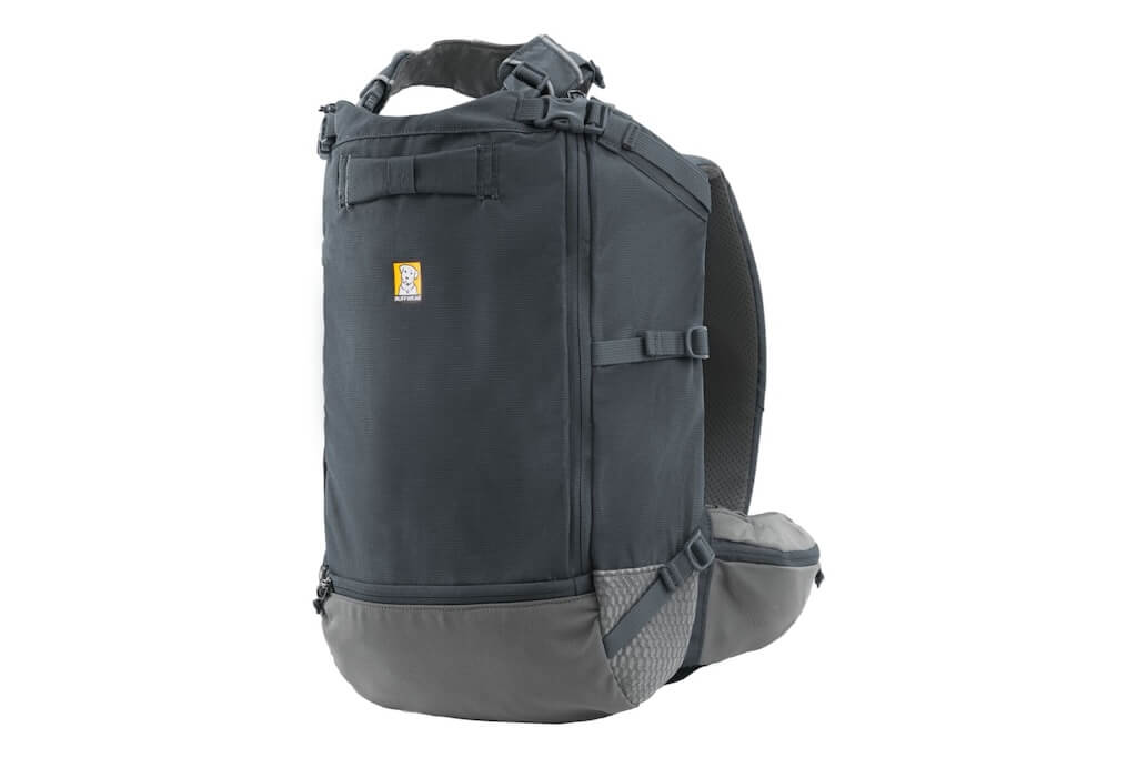 Small dog in a Ruffwear Hitch Hiker Backpack on owners back while cycling