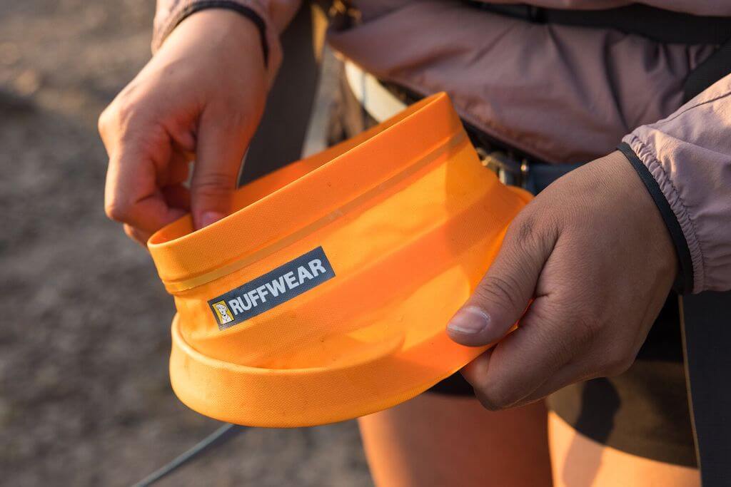 Ruffwear Bivy Bowl in Salamander Orange showing someone opening it