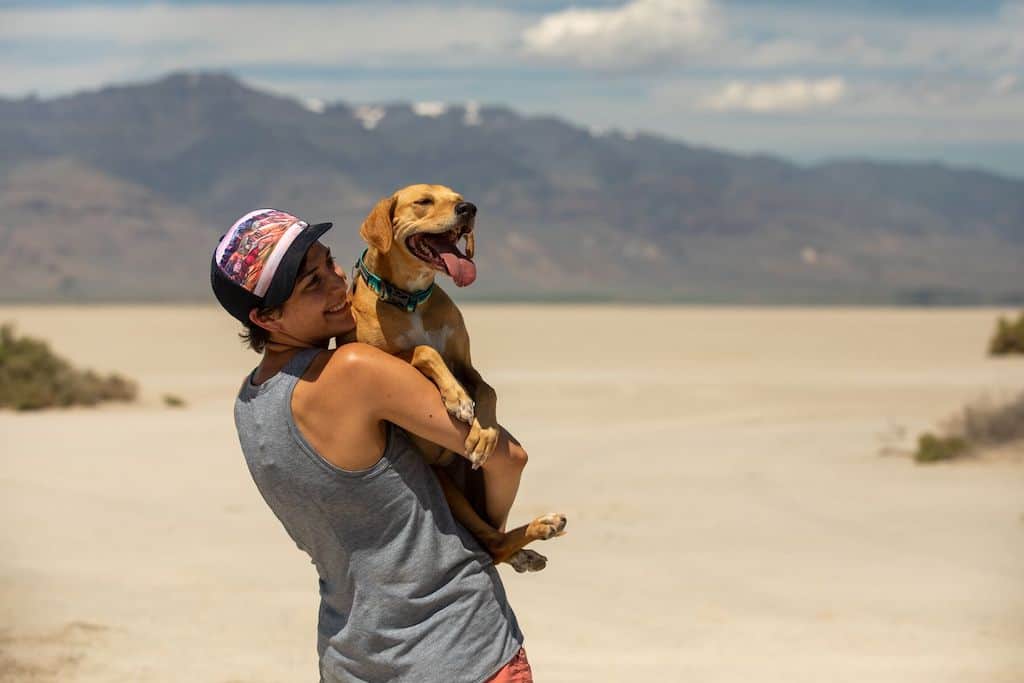 Woman holding a happy dog who is wearing a Ruffwear Crag Dog Collar
